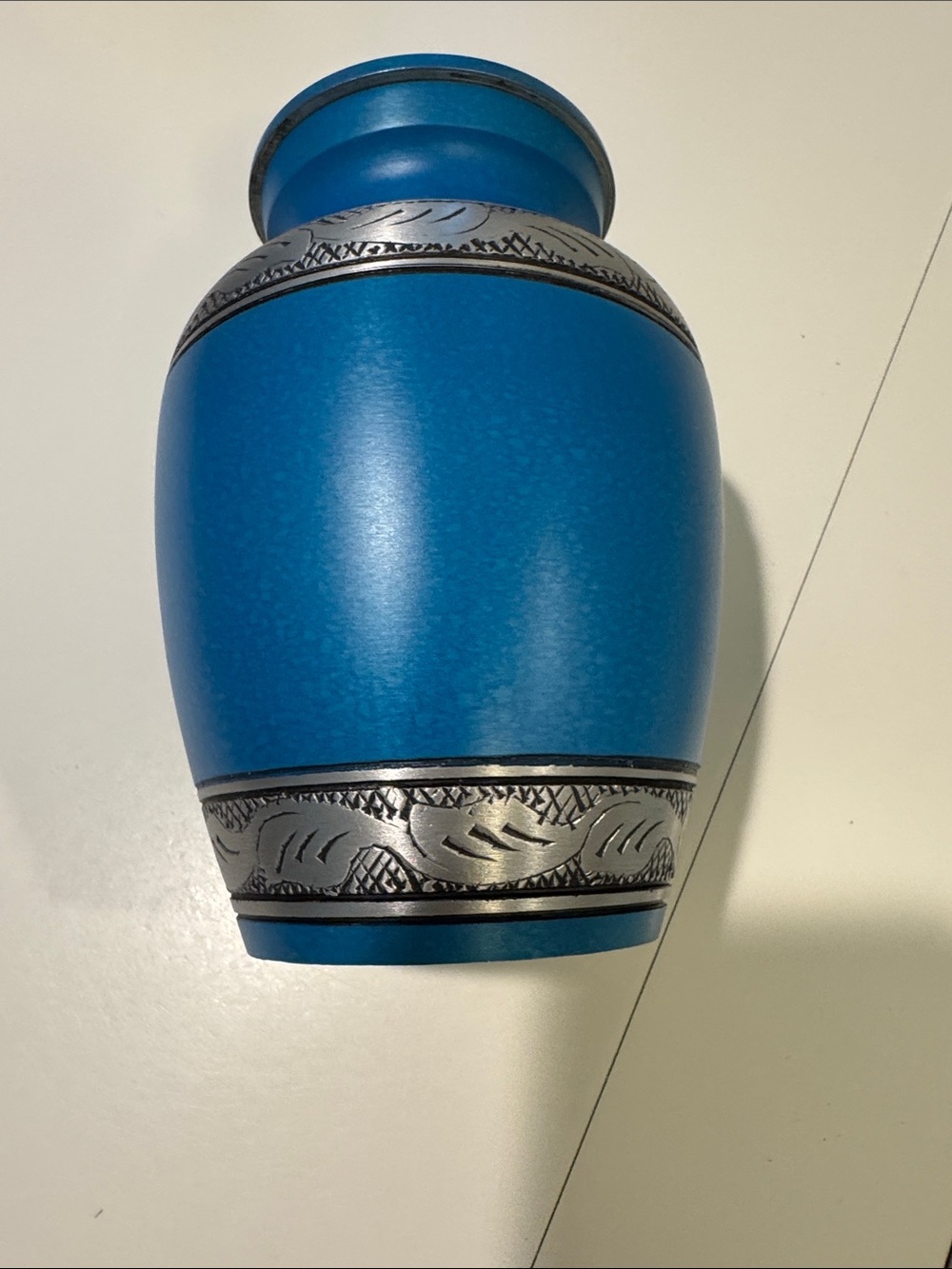 Blue Decorative Metal Urn with Silver Accent.